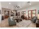 Spacious living room with a stone fireplace, recessed lighting, and large windows at 7600 E Golden Eagle Cir, Gold Canyon, AZ 85118