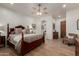 Large main bedroom with wood floors, neutral paint, ceiling fan, and private ensuite at 7600 E Golden Eagle Cir, Gold Canyon, AZ 85118