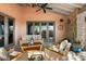 Comfortable covered patio with stylish outdoor furniture and access to the backyard at 7600 E Golden Eagle Cir, Gold Canyon, AZ 85118