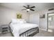 Neutral bedroom with a comfortable queen bed, ceiling fan, and closet with sliding doors at 8408 E Lewis Ave, Scottsdale, AZ 85257
