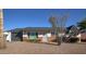 Charming single-story home featuring desert landscaping, brick accents, and a gray garage door at 8408 E Lewis Ave, Scottsdale, AZ 85257