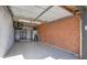 Spacious garage equipped with epoxy flooring, brick walls, overhead lighting, and additional storage space at 8408 E Lewis Ave, Scottsdale, AZ 85257