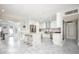 Bright kitchen with granite counters, stainless steel appliances, island with seating, and white cabinetry at 8408 E Lewis Ave, Scottsdale, AZ 85257