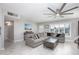 Living room features neutral decor, large sectional sofa, fan, and window shutters at 8408 E Lewis Ave, Scottsdale, AZ 85257
