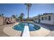Backyard oasis with diving board, pool, patio, seating, palm trees, and privacy fence at 8408 E Lewis Ave, Scottsdale, AZ 85257