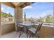 Comfortable balcony with table and chairs overlooking the community and providing a relaxing outdoor space at 8787 E Mountain View Rd # 2016, Scottsdale, AZ 85258