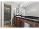 Elegant bathroom featuring granite countertop, vanity with wood cabinets, and a glass door shower, providing a luxurious experience at 8787 E Mountain View Rd # 2016, Scottsdale, AZ 85258