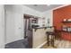 Kitchenette with bar seating, stainless steel appliances, and a door to the left for easy access to other parts of the home at 8787 E Mountain View Rd # 2016, Scottsdale, AZ 85258
