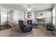 A cozy living room with a fireplace, a ceiling fan, and comfortable seating at 8787 E Mountain View Rd # 2016, Scottsdale, AZ 85258