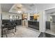 View of the living room into the kitchen; open floorplan with black marble countertops and a dining table at 8787 E Mountain View Rd # 2016, Scottsdale, AZ 85258