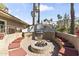 Inviting outdoor kitchen featuring a built-in grill, seating, and a cozy fire pit perfect for entertaining at 8787 E Mountain View Rd # 2016, Scottsdale, AZ 85258