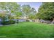 Spacious backyard features a manicured lawn and mature trees at 9041 N 46Th St, Phoenix, AZ 85028