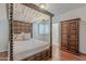 Charming bedroom featuring a canopy bed, wood floors, and window with plantation shutters at 9041 N 46Th St, Phoenix, AZ 85028