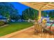 Relaxing covered patio with furniture overlooking the lush backyard and pool at 9041 N 46Th St, Phoenix, AZ 85028