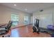 Spacious exercise room with built-in desk area and exercise equipment on wood floors at 9041 N 46Th St, Phoenix, AZ 85028