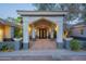 Covered front entrance with illuminated lanterns and potted plants at 9041 N 46Th St, Phoenix, AZ 85028