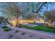 Stunning home exterior with a lush, landscaped yard and multi-car garage, illuminated at dusk at 9041 N 46Th St, Phoenix, AZ 85028