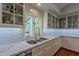 A well-lit kitchen offers stainless steel appliances, white cabinets, stone countertops, and a window view at 9041 N 46Th St, Phoenix, AZ 85028