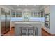 This kitchen features an island with seating, white cabinets, stone countertops, and stainless steel appliances at 9041 N 46Th St, Phoenix, AZ 85028