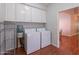 Functional laundry room featuring washer, dryer, and ample overhead storage cabinets at 9041 N 46Th St, Phoenix, AZ 85028