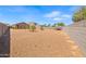 Backyard with a gravel surface and block walls, featuring trees and a trampoline at 4053 N 308Th Ln, Buckeye, AZ 85396