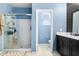 View of the ensuite bathroom with glass shower and modern vanity at 4053 N 308Th Ln, Buckeye, AZ 85396