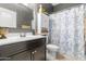 Bathroom featuring a dark vanity, floral shower curtain, and neutral-colored walls at 4053 N 308Th Ln, Buckeye, AZ 85396