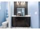 Close up of the double vanity in the bathroom with dark wood paneling at 4053 N 308Th Ln, Buckeye, AZ 85396