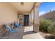 Inviting front porch with seating and stone accents, creating a welcoming entrance to the home at 4053 N 308Th Ln, Buckeye, AZ 85396