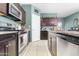 Well-equipped kitchen featuring stainless steel appliances, granite countertops, and ample cabinet space at 4053 N 308Th Ln, Buckeye, AZ 85396
