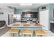 Charming kitchen boasting an island with bar stools, granite counters, and stainless steel appliances at 4053 N 308Th Ln, Buckeye, AZ 85396