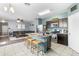 Open kitchen and living area with an island, bar seating, stainless appliances, and modern finishes at 4053 N 308Th Ln, Buckeye, AZ 85396