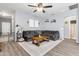 Comfortable living room with a large gray sectional, wood floors, and bright, neutral decor at 4053 N 308Th Ln, Buckeye, AZ 85396