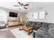 Cozy living room featuring a plush sectional, wood-look flooring, and neutral decor with a TV at 4053 N 308Th Ln, Buckeye, AZ 85396