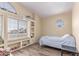 Well-lit bedroom features built-in bookshelves, a window seat, and a small window above the bed at 4302 E Mountain Vista Dr, Phoenix, AZ 85048