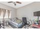 A well-lit bedroom featuring a ceiling fan, neutral walls, and a comfy grey and blue bed at 4302 E Mountain Vista Dr, Phoenix, AZ 85048