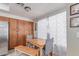 Dining area with a wooden table set next to the kitchen, illuminated by natural light at 4302 E Mountain Vista Dr, Phoenix, AZ 85048