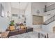 Bright and open living area with tall ceilings, a cozy leather couch, and staircase access at 4302 E Mountain Vista Dr, Phoenix, AZ 85048