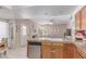 Open-concept kitchen and living room featuring a cozy fireplace at 4302 E Mountain Vista Dr, Phoenix, AZ 85048
