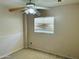Standard bedroom with ceiling fan, window with blinds and neutral-colored carpet at , Tempe, AZ 85282