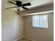 Cozy bedroom with a ceiling fan, a window providing natural light and patterned carpet at , Tempe, AZ 85282