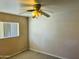 Modest bedroom with ceiling fan, a window with blinds and neutral-colored carpet at , Tempe, AZ 85282
