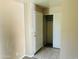 Simple bedroom with tiled floors, closet, and a white paneled door, perfect for rest and relaxation at , Tempe, AZ 85282