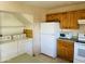 Cozy kitchen includes a laundry area, light wood cabinets, and white appliances for convenient living at , Tempe, AZ 85282