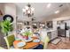 Bright dining area with a chandelier, open floorplan and modern kitchen amenities at 10804 W Mohawk Ln, Peoria, AZ 85373