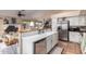 Modern kitchen with bright countertops, stainless steel appliances, and open to the living area at 10804 W Mohawk Ln, Peoria, AZ 85373