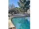 Stunning lake view from the backyard with a fence, rock landscaping, and partial view of the house at 10804 W Mohawk Ln, Peoria, AZ 85373