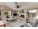 Spacious living room with lots of natural light, fireplace, and views of the backyard at 10804 W Mohawk Ln, Peoria, AZ 85373