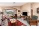 Cozy living room with a comfortable seating area and natural light from the large window at 10804 W Mohawk Ln, Peoria, AZ 85373