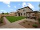Spacious backyard featuring a lush lawn, patio area, and a pergola at 15758 W Cortez St, Surprise, AZ 85379